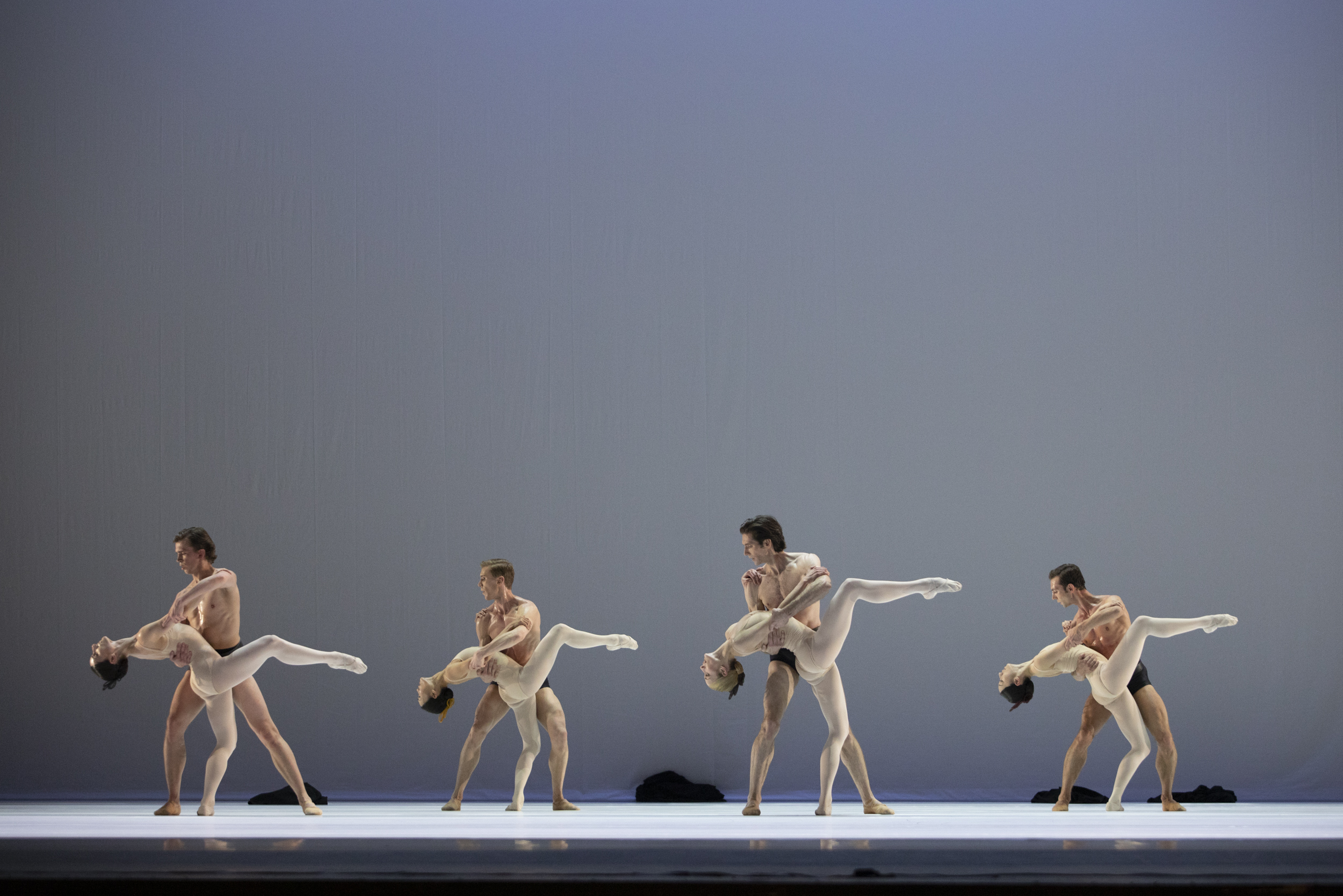 Four paits of dancers on the stage wearing nude costumes
