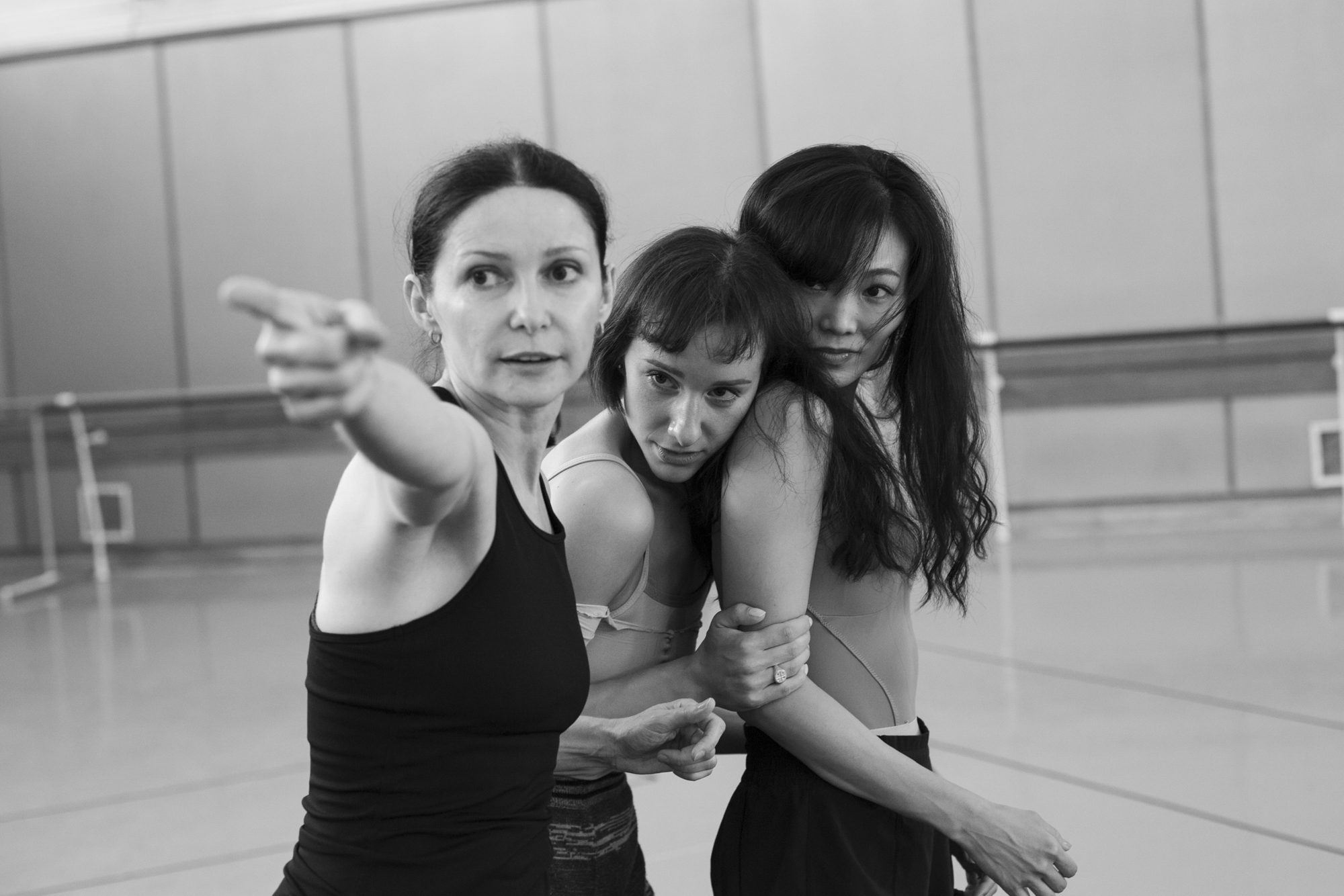 Two female dancers look into the distance where the choroegrapher is pointing.