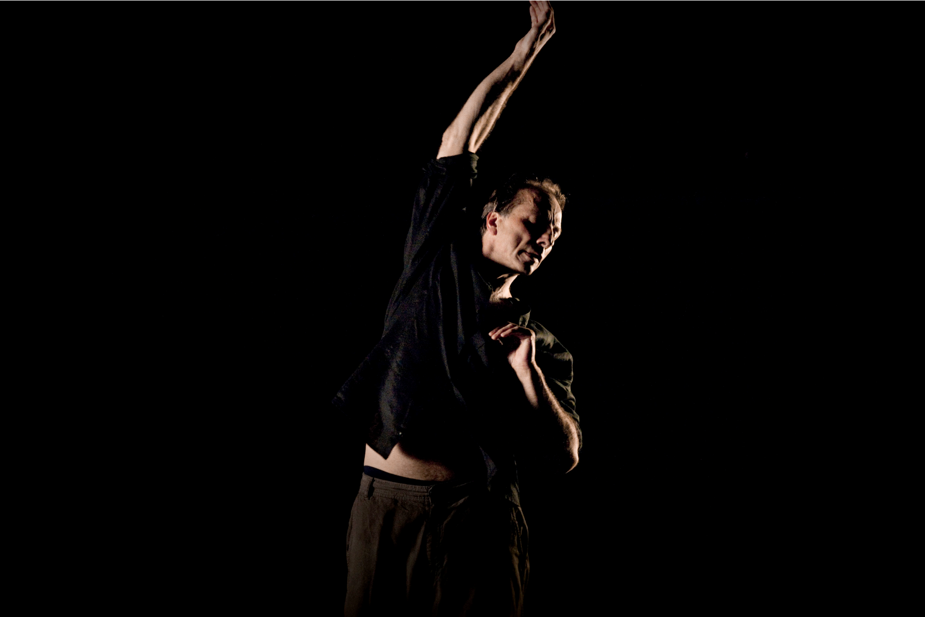 The choreographer in a dance pose with his hand extended over his head